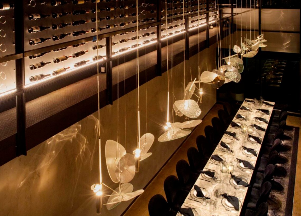 private room with dinning table and bottles Private room with dinning table and wine bottles.